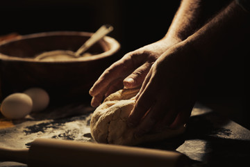 Wall Mural - Hands of man making dough in kitchen