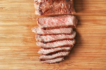 Sticker - Sliced tasty steak on wooden board