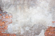 Leinwandbild Motiv brick wall with damaged plaster, background shattered cement surface
