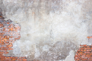 brick wall with damaged plaster, background shattered cement surface