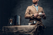 © Fxquadro - A man near a table with coffee machine over grey background.