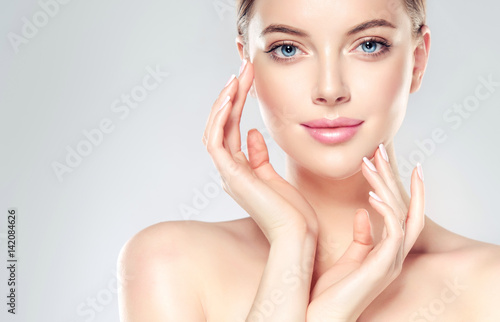Fotografie, Obraz Beautiful Young Woman with Clean Fresh Skin touch own face