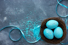 Three Blue Speckled Eggs In Bird Nest , Easter Holiday Decorations