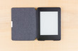 E-book reader with blank page on wooden background