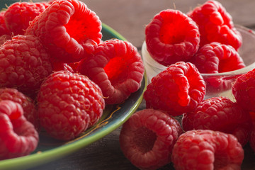 raspberries on the wooden background.