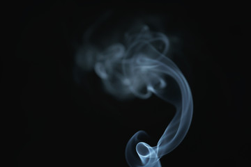 Wall Mural - mystery wavy smoke rising over black background