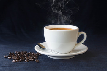 coffee cup and beans on a dark background