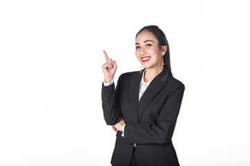 Wall Mural - Young beautiful Asian businesswoman pointing something on white background. Image with clipping path.