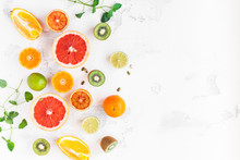 Fruit Background. Colorful Fresh Fruit On White Table. Orange, Tangerine, Lime, Kiwi, Grapefruit. Flat Lay, Top View, Copy Space