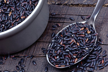 Wall Mural - Black rice in a spoon and pot on table