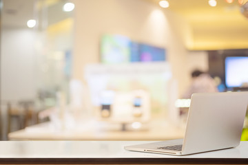 Mock up laptop on white wood top table and office background. for Product display montage