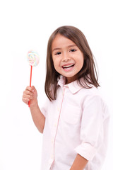 Wall Mural - happy, smiling cute little girl eating marshmallow sweet candy