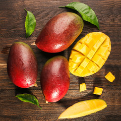 Wall Mural - Slised ripe mango on wooded board.