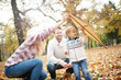 © chika_milan - Parents and their child playing in the park, boy trying fly a kite
