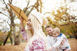 © chika_milan - Caucasian family in the park having fun, mum flying a kite