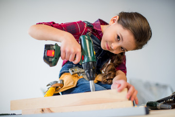 Wall Mural - Girl drilling plank