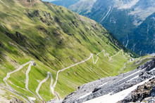 Alps Mountain Road Passo Dello Stelvio Famous For Its Auto And Bike Extreme Driving. Stelvio Pass Serpentine Roadway, Italy, Near The Borders Of Switzerland And Austria.