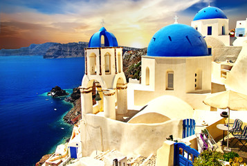 Wall Mural - Amazing Santorini over sunrise. View of Oia village with famous blue churches. Greece