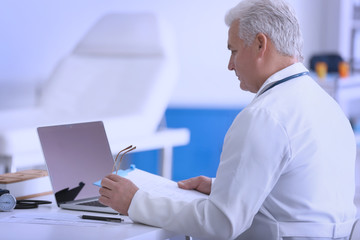 Poster - Male doctor at work in clinic