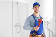 © Africa Studio - Young plumber holding pipe wrench in bathroom