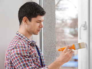 Sticker - Young man painting window in office