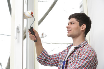 Sticker - Young man painting window in office