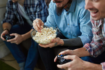 Wall Mural - Closeup portrait of three excited adult men enjoying video game battle and cheering