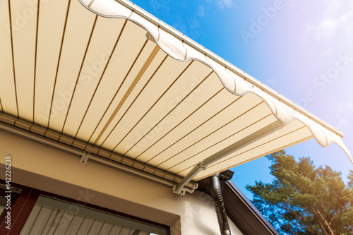 Fotografie, Obraz awning over balcony window against blue sky