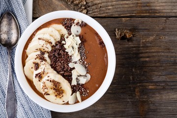 Wall Mural - Chocolate smoothie bowl with banana, chia seeds and almond chips