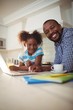 © WavebreakMediaMicro - Portrait of father and daughter with laptop