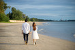 © Panot - Happy Romantic young Couple Enjoying Beautiful Sunset Walk on the Beach.