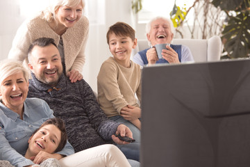 Multigenerational family watching television