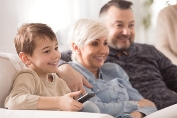 Wall Mural - Boy watching film with parents