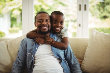 Son embracing his father at home