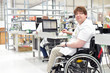 © industrieblick - Rollstuhlfahrer am Arbeitsplatz in einer Fabrik zur Montage von Elektronik - Alltag mit Gehbehinderung // Wheelchair driver at the workplace in the industry