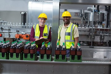 Portrait of two factory workers monitoring cold 