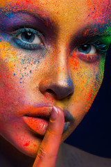 Wall Mural - Model with art make-up posing on dark background
