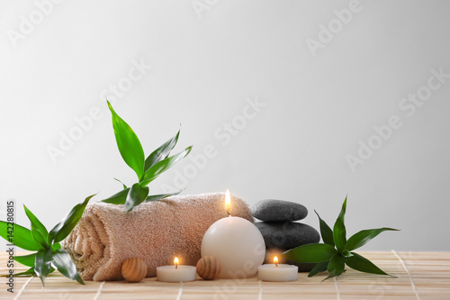 Fototeppich diamond velvet - Spa stones, towel and candles on color background (von Africa Studio)