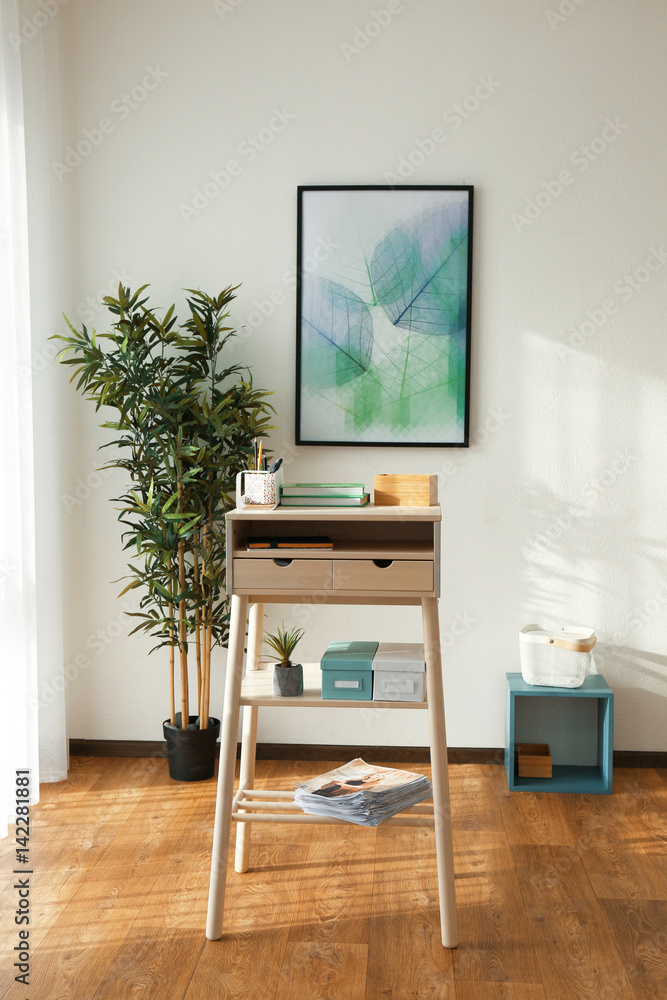 High wooden table as stand up work place in modern interior