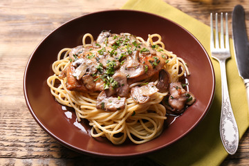 Wall Mural - Plate with delicious chicken marsala and spaghetti on table