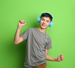 Poster - Teenager with headphones listening to music on color background