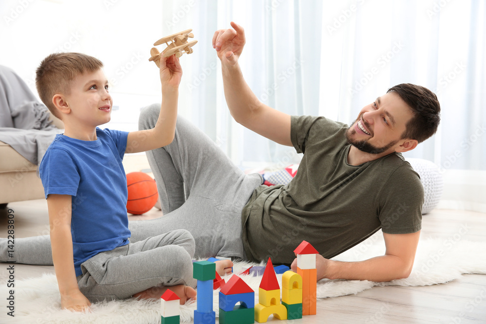 Father playing with his son at home