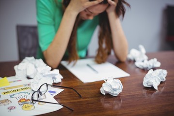 Wall Mural - Frustrated female business executive sitting 