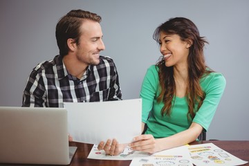 Wall Mural - Male and graphic designers working together in conference room