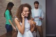 © WavebreakMediaMicro - Female executive talking on mobile phone in office