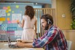 © WavebreakMediaMicro - Male graphic designer listening song while using laptop