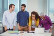 © WavebreakMediaMicro - Smiling graphic designers interacting with each other