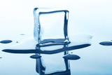 Fototapeta Łazienka - Melting ice cube with reflection isolated on white.