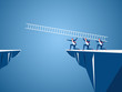 Business team using ladder to cross through the gap between hill. Business Teamwork ,risk and success concept.