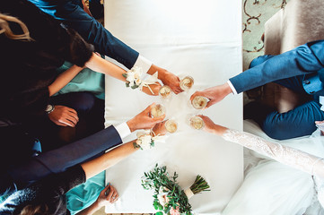 Wall Mural - People hold in hands glasses with white wine. wedding party.